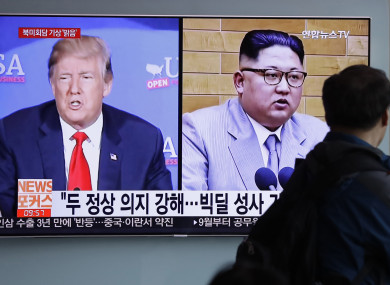 In this May 11, 2018, file photo, a man watches a TV screen showing file footage of U.S. President Donald Trump, left, and North Korean leader Kim Jong Un.