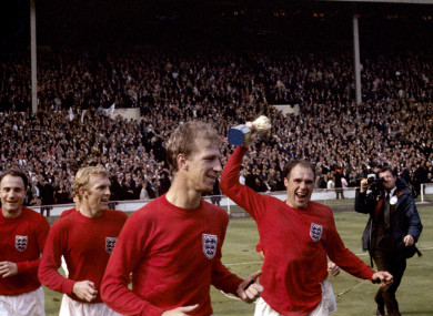 Wilson lifting the World Cup trophy with team-mates George Cohen, Bobby Moore and Jack Charlton.