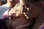 Abigail Adams, right, comforts her friend Hannah Hershey during a vigil for the victims of the Santa Fe High School shooting on Friday.