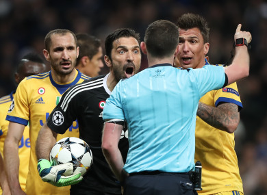 Buffon protests to Oliver.