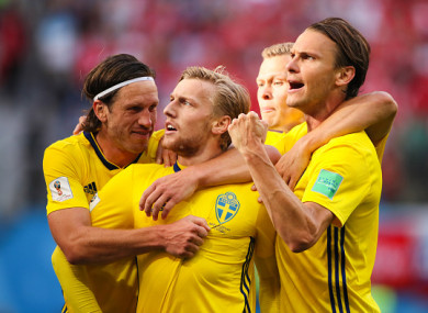 Forsberg celebrates with team-mates after giving the Sweden the lead.