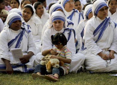 2016 photo of nuns from The Missionaries of Charity with an orphan girl in Kolkata.