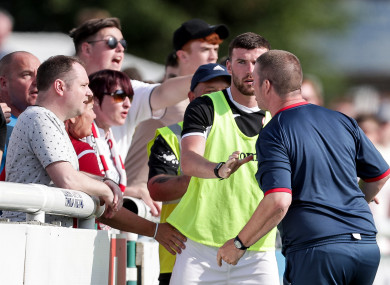 Sligo's goalkeeper coach Rodney Dalzell argues with supporters as Patrick McClean attempts to calm him.