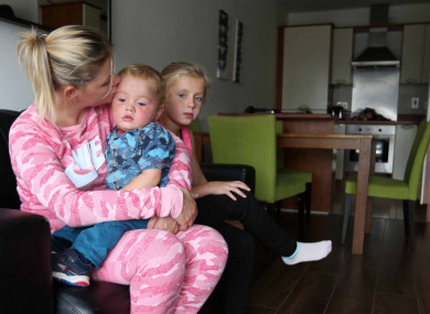 Dublin mother Margaret Cash is photographed with her children after being given access to temporary accommodation.
