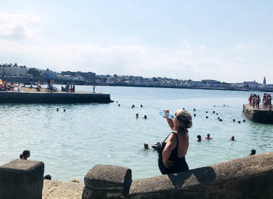File photo. People swimming in the sea during the hot weather this summer.