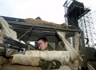File: A soldier keeps watch as Army sappers dismantle Cloghoge Watchtower in south Armagh, one of two hilltop watchtowers being dismantled in the area