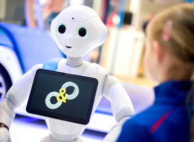 Pepper the robot, speaking to a young girl.