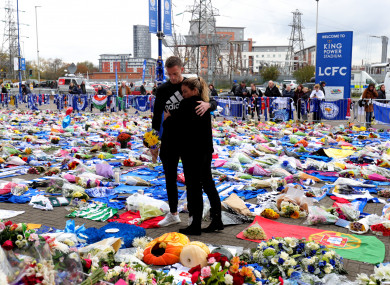 Leicester midfielder Andy King and his wife Camilla pay their respects.