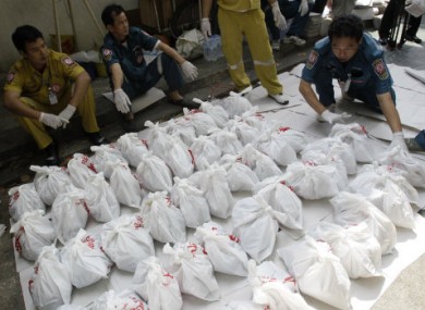 Rescue workers arrange bags containing dead foetuses found at the morgue of a Buddhist temple in Bangkok.