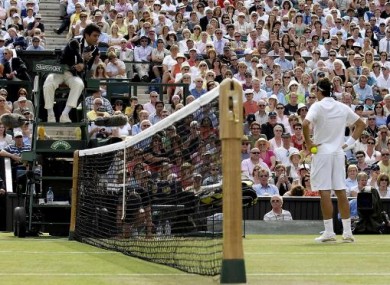 Roger Federer argues with the umpire following Hawk-Eye decision against him, in his match against Spain's Rafael Nadal during The All England Lawn Tennis Championship at Wimbledon.