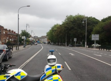 A Garda traffic motorbike holds off traffic into a deserted Fairview during an ongoing security alert there today.
