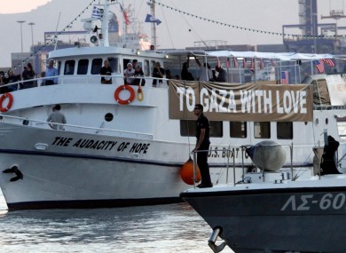The Audacity of Hope is escorted by the Greek coast guard ship in the town of Perama, near Athens yesterday