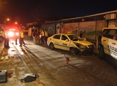 Israeli policemen gather at a site where a Palestinian man crashed a car into a crowed of people and stabbed seven people near a nightclub in Tel Aviv, early Monday, Aug. 29, 2011.