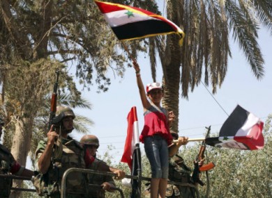 Image of a young girl carrying a Syrian flag as troops withdraw from Deir el-Zour earlier this week. The photo was taken during a Government organised media tour.