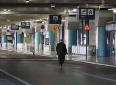 A man walks at the empty arrival terminal during a 12-hour work stoppage by air traffic controllers at the Athens International Airport.