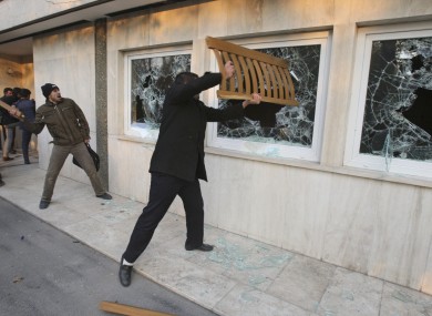 Iranian protesters break the windows of a British Embassy building, in Tehran, Iran, Tuesday, Nov. 29, 2011.