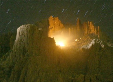 A helicopter search light looks over the scene of an aircraft that crashed in the Superstition Mountains in Apache Junction, on Wednesday, 23 November, 2011.