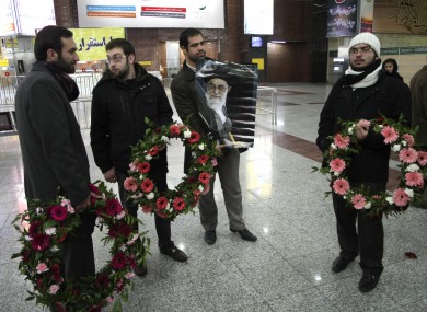 A group of demonstrators waits at Tehran airport to welcome the Iranian diplomats expelled from Britain.