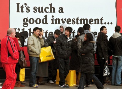 Shoppers wait outside Selfridges in London on Boxing Day 2008.