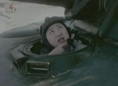 In this undated image made from KRT video, North Korea's new young leader Kim Jong Un appears from a military vehicle at an undisclosed place in North Korea