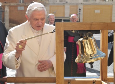 Pope Benedict XVI rings the bell of the International Eucharistic Congress, watched by (background) Fr Kevin Doran and Dr Diarmuid Martin.