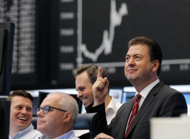 A trader smiles as news of the German constitutional court's ruling on a challenge to the ESM filters through in Frankfurt.
