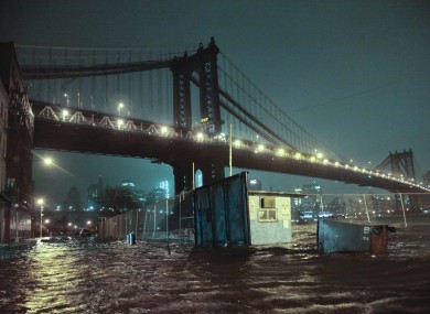 Streets are flooded under the Manhattan Bridge in the Dumbo section of Brooklyn, N.Y..