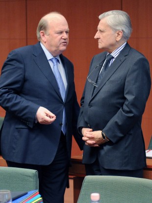 Michael Noonan speaks with Jean-Claude Trichet, the then-ECB president, at Noonan's meeting of European finance ministers in March 2011.