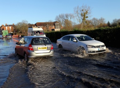Cars make their way through flood water on Pershore High Street in Pershore, Worcestershire, as south-west Britain comes to terms with severe storms and flooding.