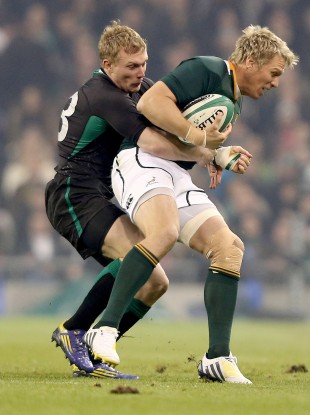 Springbok captain Jean de Villiers is tackled by Keith Earls.