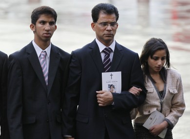 Husband of late Jacintha Saldanha, Benedict Barboza, center, son Junal, 16, and daughter Lisha, 14, arrive at Westminster Cathedral in London for a memorial service.