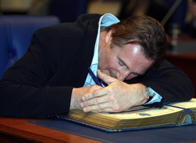 Liam Neeson signs the Register of Burgess as he accepts the freedom of Ballymena today.