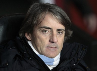 Manchester City's manager Roberto Mancini looks on from the dugout before the start of their English Premier League soccer match against Southampton.