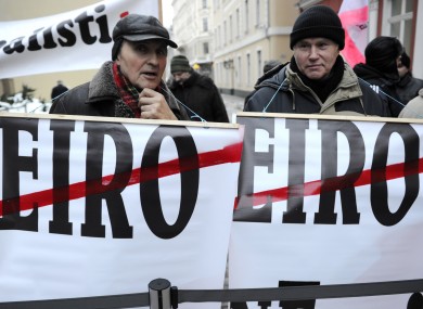 Demonstrators holding posters during a protest at the Latvian parliament in Riga, Latvia, earlier this week.