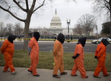 Demonstrators dressed as detainees march past the Capitol building during a rally against the US military detention facility in Guantanamo Bay in January.