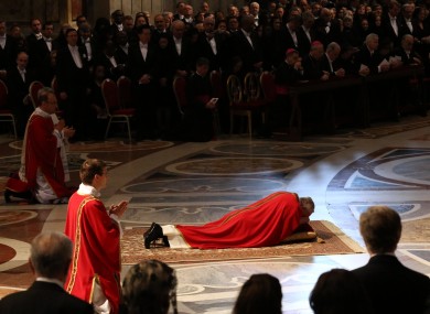 Pope Francis lies down in prayer during the mass at St Peter's Basilica today