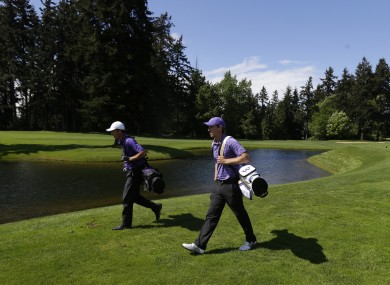 Williams, right, walks alongside University of Washington teammate Trevor Simsby