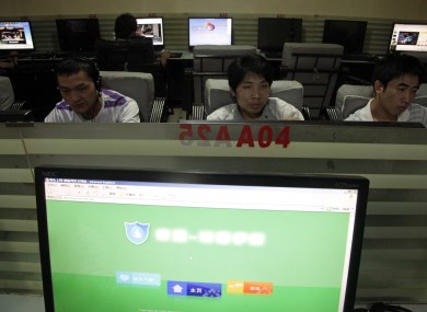 In this photo taken Wednesday, July 14, 2010, Chinese men use computers at an Internet cafe in Beijing.