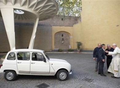 Pope Francis, right, speaks with Rev. Renzo Zocca, second from right, and owner of the Renault 4L seen at left, his assistant Luigi Macchioni, and car-body repairer Stefano Veronesi, fourth from right, after he was donated the car by Zocca.