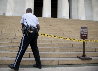 A US Park Police officer pulls police tape across the steps closing access to the Lincoln Memorial in Washington
