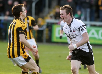 Kilcoo's Paul Devlin celebrates after scoring a goal while Crossmaglen's Stephen Kernan looks on.