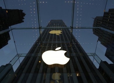 The Apple logo is illuminated in the entrance to the Fifth Avenue Apple store.