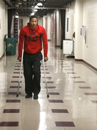 Chicago Bulls star Derrick Rose walks down the hall on crutches to a news conference today.
