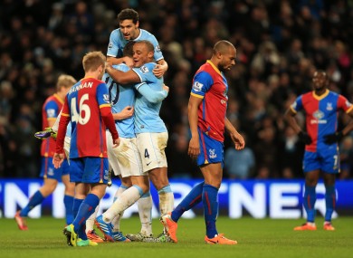Edin Dzeko is swamped by teammates after scoring against Crystal Palace.