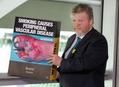 Health Minister James Reilly with an outsize version of the Australian 'plain pack' cigarette box design.