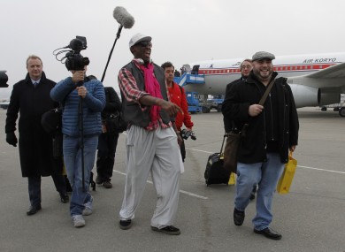 Rodman arriving at Pyongyang airport with his entourage, including Cooper (far left), earlier today.