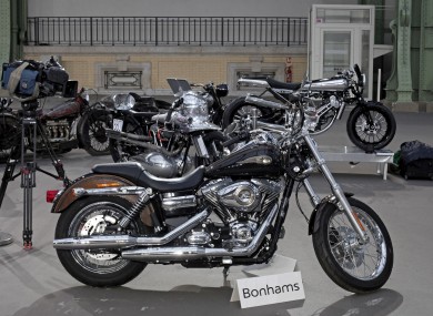 The 2013 Harley DavidsonSuper Glide Custom A 1,585cc Harley-Davidson Dyna Super Glide, donated to Pope Francis last year and signed by him on its tank, is displayed ahead of Bonham's sale of vintage and classic cars, at the Grand Palais in Paris. The bike was sold at auction to help raise funds for a soup kitchen and hostel for the homeless in Rome.
