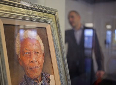 A painting of former South African president Nelson Mandela by British artist Richard Stone is displayed at a art exhibition in his honor at Cape Town.