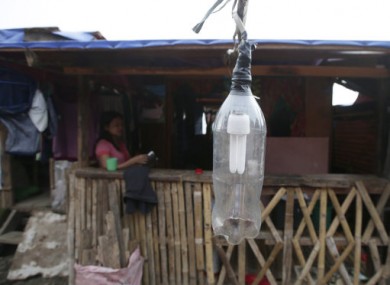 Typhoon survivors rebuild their homes as they recover from Typhoon Haiyan.