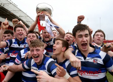 The Crescent College players celebrate as captain Cormac Blake lifts the cup.